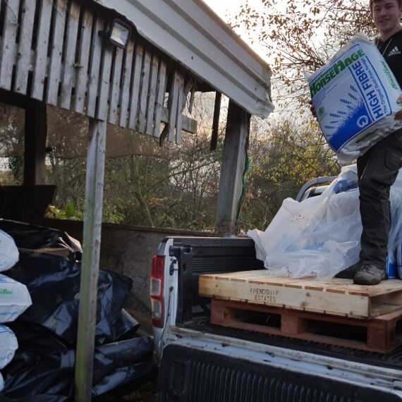 Jon-Paul helping unload HorseHage and Mollichaff for flooded village.